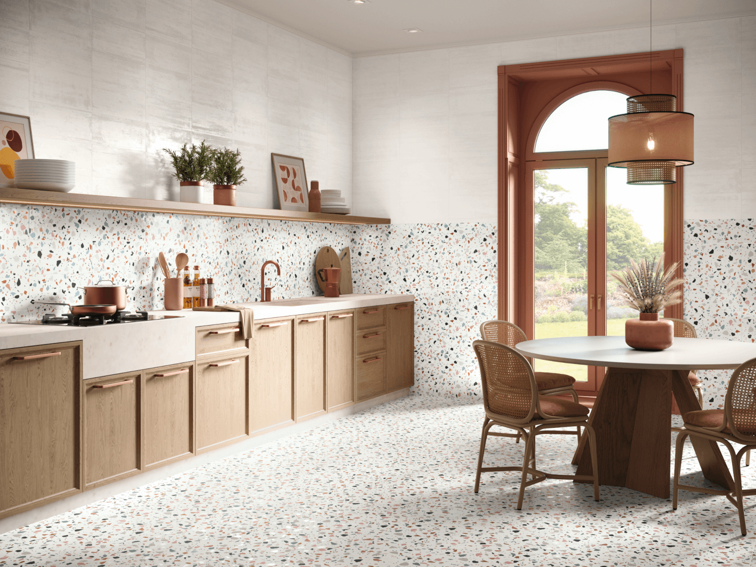 Elevate Your Space with Terrazzo Tiles: A Timeless Design Choice 14 A kitchen and dining area featuring a terrazzo tile floor and matching terrazzo tiles on the backsplash and lower wall, with a speckled pattern of red, black, blue, and yellow chips.
